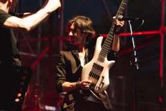 Luca Zabbini on stage with PFM under red lights